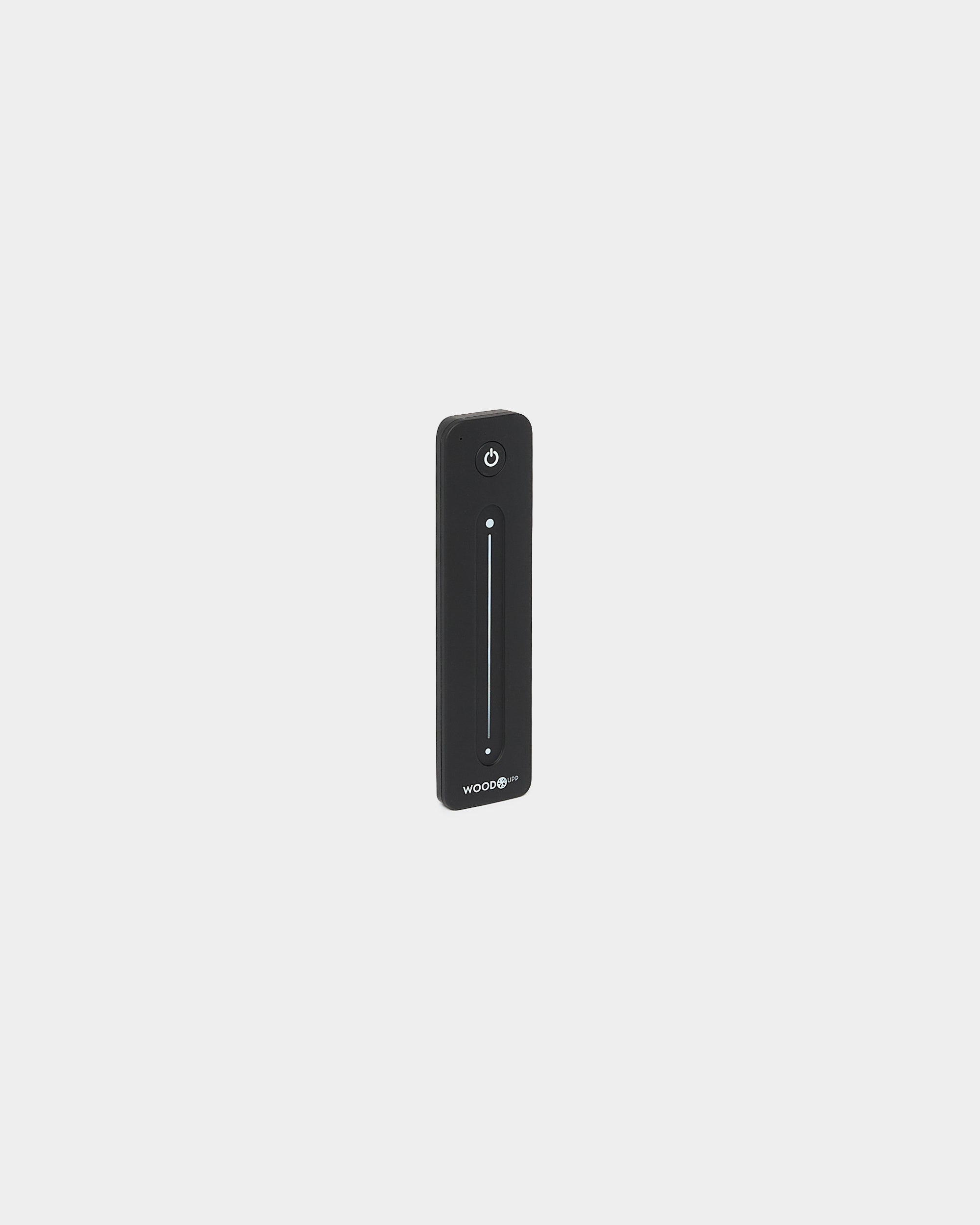 Slanke black WoodUpp Lumi afstandsbediening voor LED-striplights, met vertical touchslider en aan-uitknop, compatibel met Philips Hue, afgebeeld op een witte achtergrond.