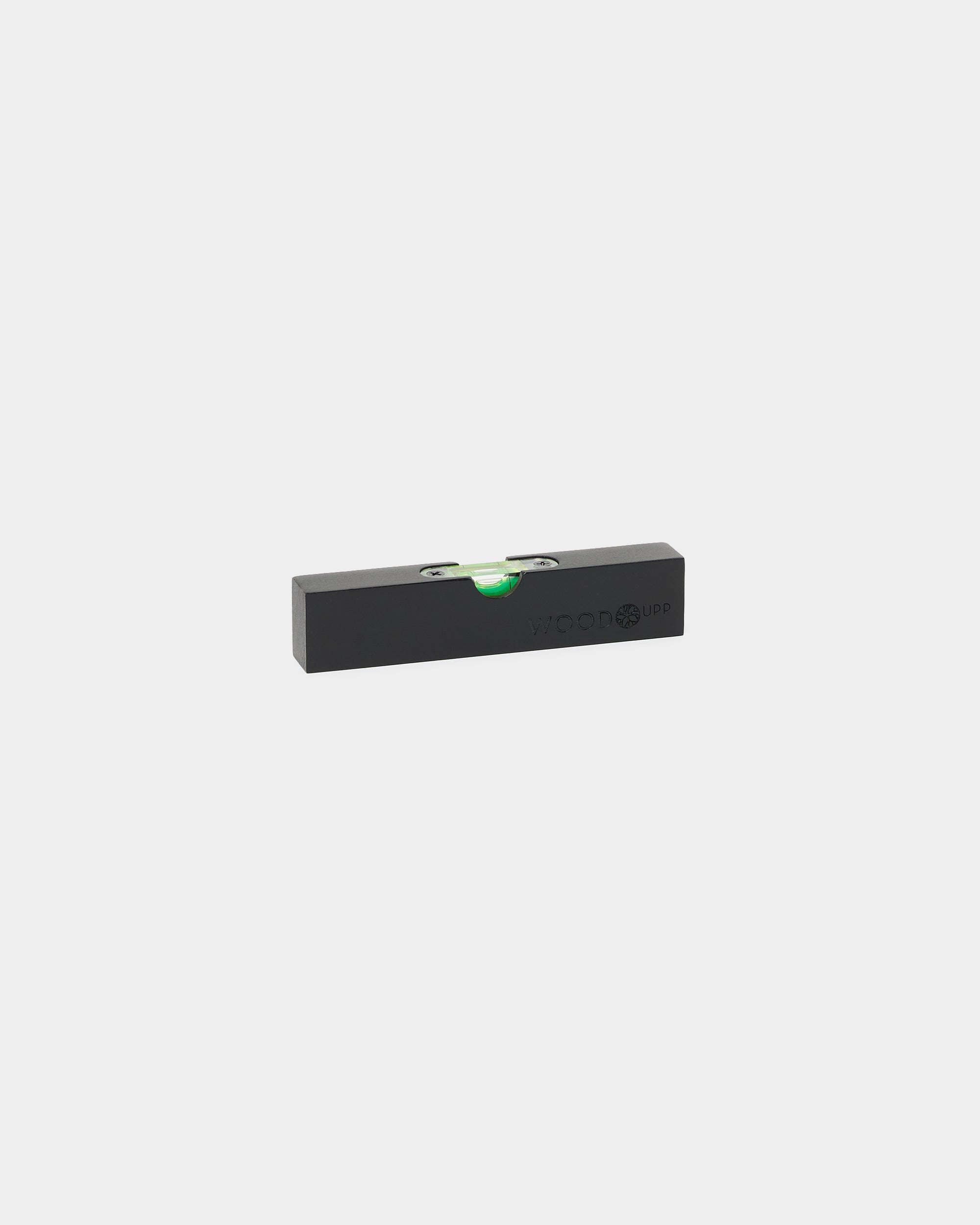Black WoodUpp waterpas (15 x 3,2 cm) met groene libel, ontworpen voor de nauwkeurige montage van Akupanel of andere akoestische panelen en accessoires van WoodUpp.
