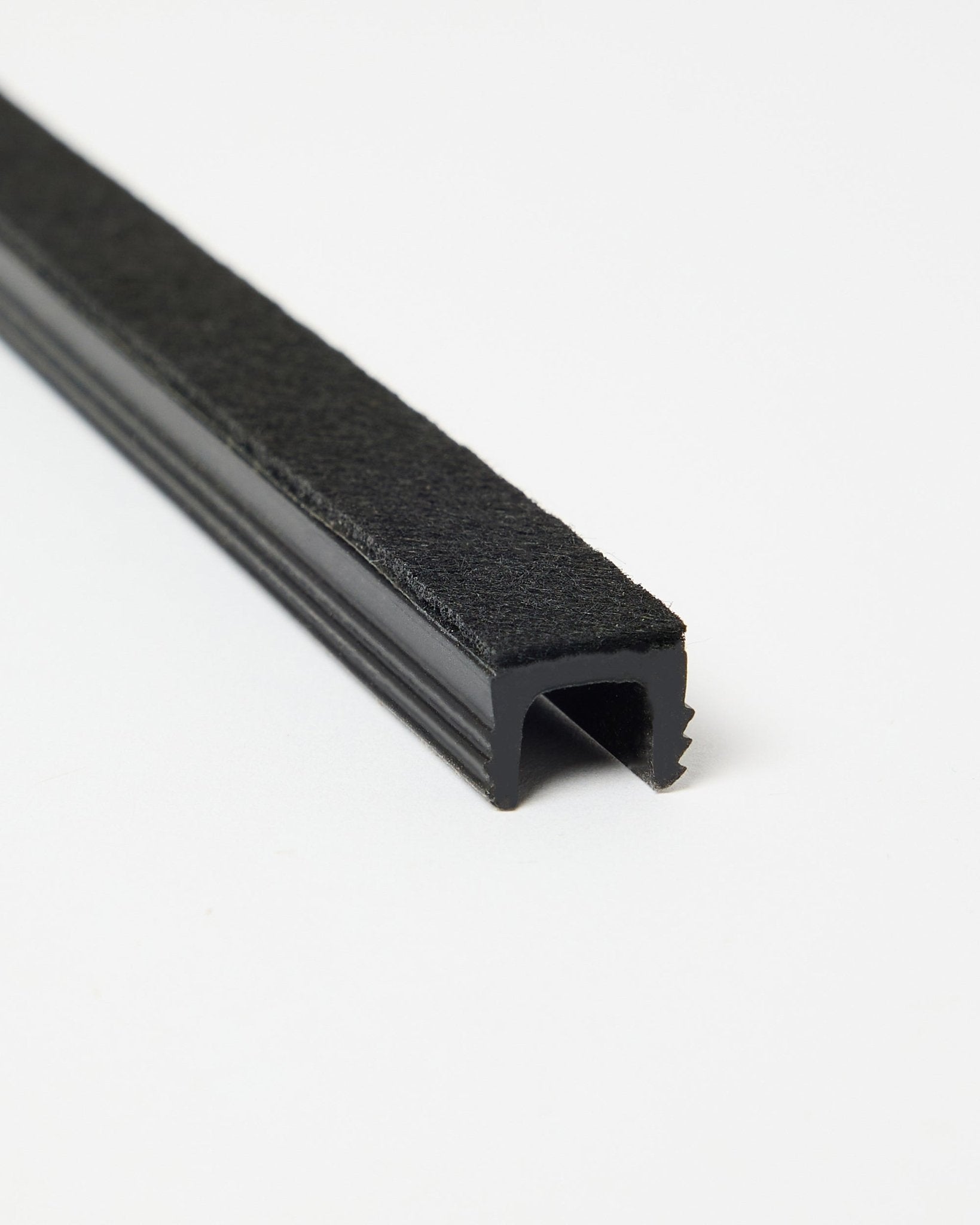 Drie black Dupps Pop-on Cable Covers van WoodUpp, schuin weergegeven op een witte achtergrond om de vorm en afwerking te laten zien. Accessoires voor Akupanel systemen.